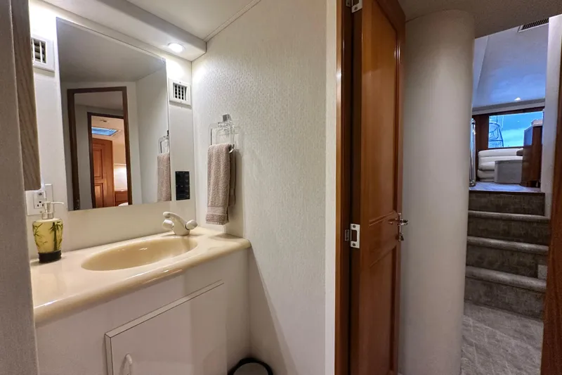 Slide: The Image of Bathroom interior of 1997 Viking 58 Convertible yacht with sink and mirror. - 128
