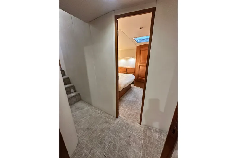 Slide: The Image of Interior view of a 1997 Viking 58 Convertible yacht bedroom with cozy lighting. - 129