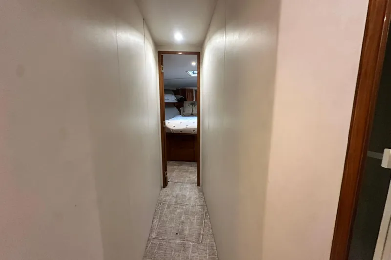 Slide: The Image of Narrow hallway leading to a bedroom on a 1997 Viking 58 Convertible yacht. - 132