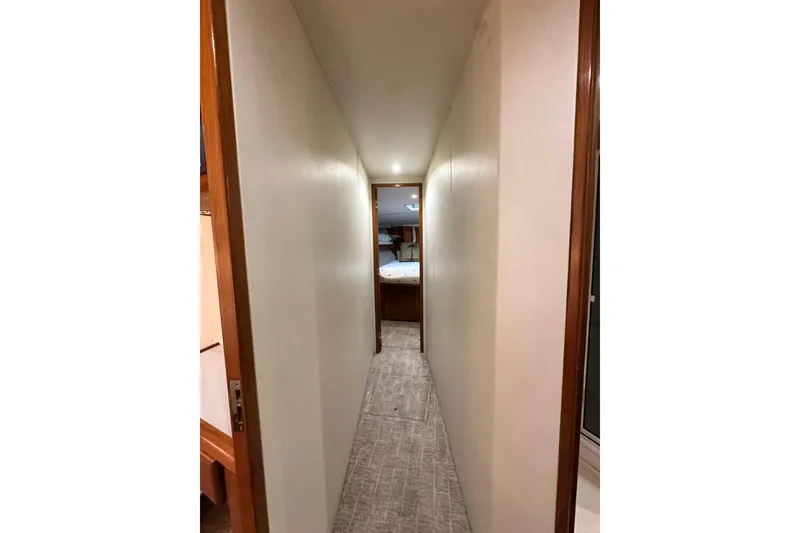 Slide: The Image of Narrow hallway inside 1997 Viking 58 Convertible yacht, leading to a bedroom. - 133