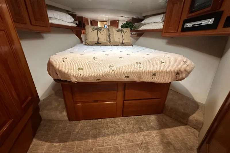 Slide: The Image of Cozy bedroom in 1997 Viking 58 Convertible yacht with palm-themed bedding. - 136