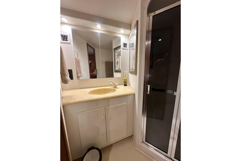 Slide: The Image of Bathroom vanity with mirror and shower in 1997 Viking 58 Convertible yacht. - 141