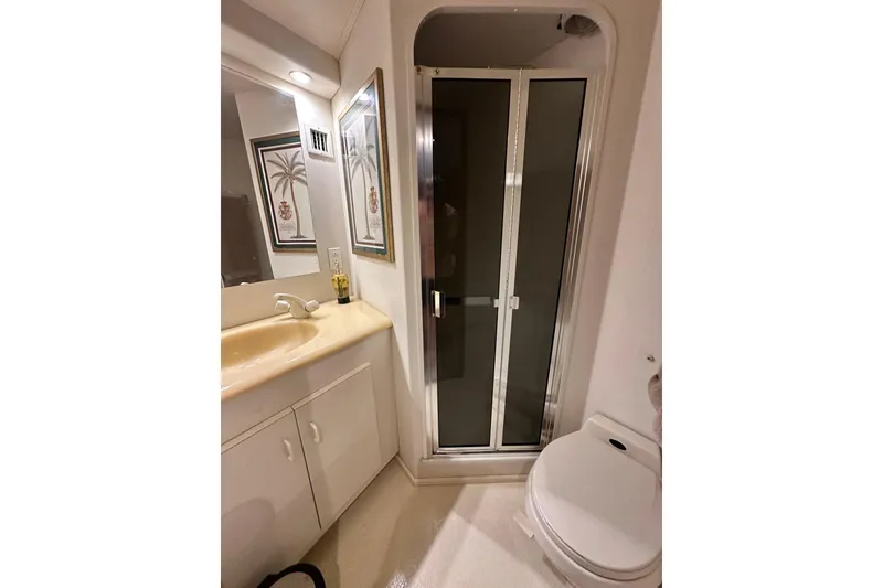 Slide: The Image of Bathroom interior of 1997 Viking 58 Convertible yacht with shower and vanity. - 142