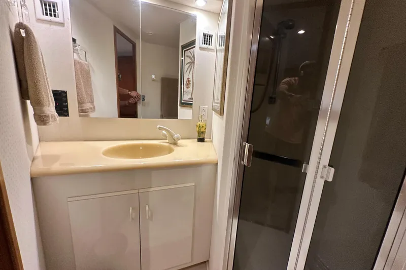 Slide: The Image of Bathroom interior of 1997 Viking 58 Convertible yacht with sink and shower. - 143