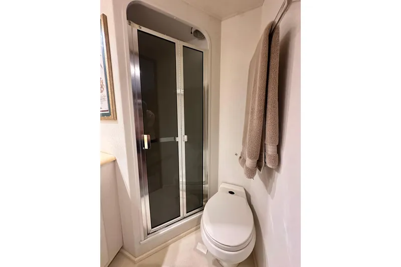 Slide: The Image of Bathroom interior of 1997 Viking 58 Convertible yacht with shower and toilet. - 147
