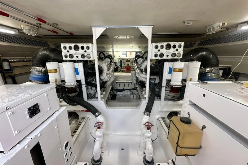 Slide: The Image of Engine room of a 1997 Viking 58 Convertible yacht, showcasing machinery and control panels. - 149