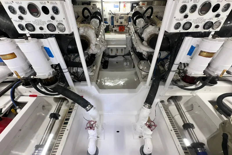 Slide: The Image of Engine room of a 1997 Viking 58 Convertible yacht, showcasing dual engines and control panels. - 150