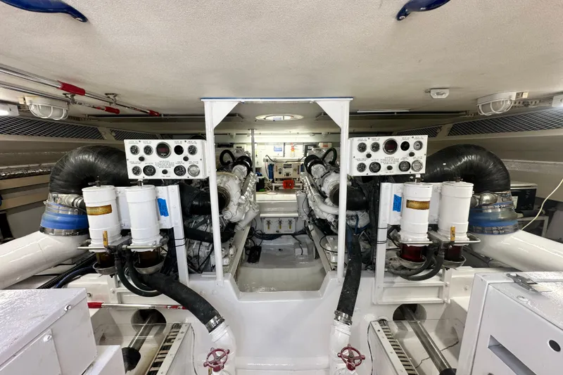 Slide: The Image of Engine room of a 1997 Viking 58 Convertible yacht, showcasing dual engines and control panels. - 152