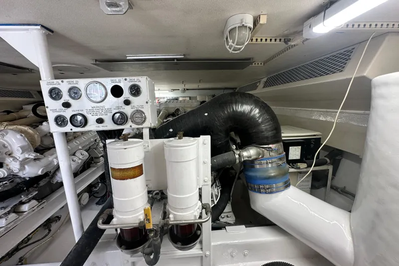 Slide: The Image of Engine room of a 1997 Viking 58 Convertible yacht, showcasing gauges and machinery. - 153