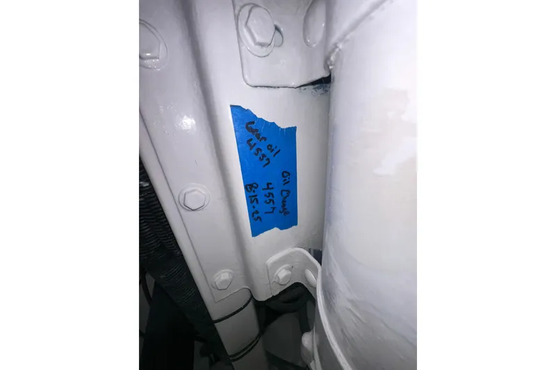 Slide: The Image of Close-up of a 1997 Viking 58 Convertible engine part with maintenance note. - 158
