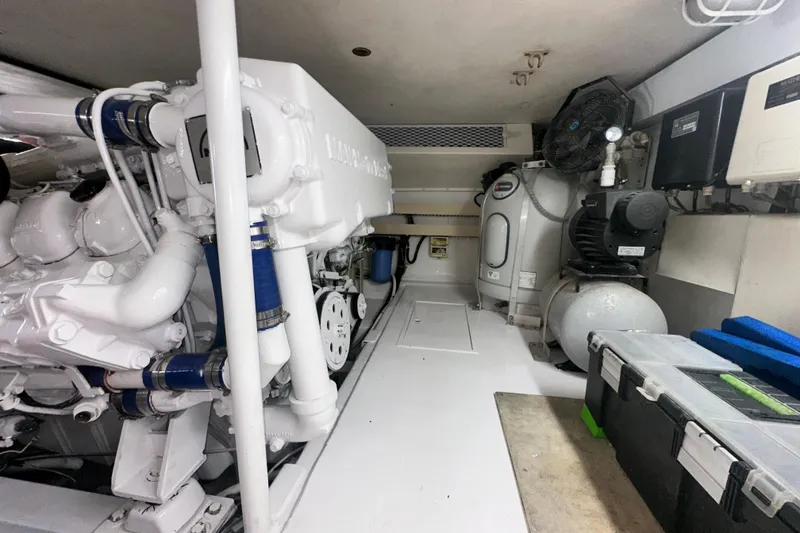 Slide: The Image of Engine room of a 1997 Viking 58 Convertible yacht, showcasing machinery and equipment. - 162