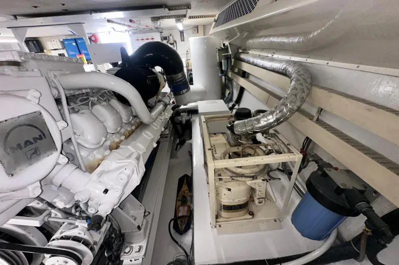 Slide: The Image of Engine room of a 1997 Viking 58 Convertible yacht, featuring a MAN engine. - 165