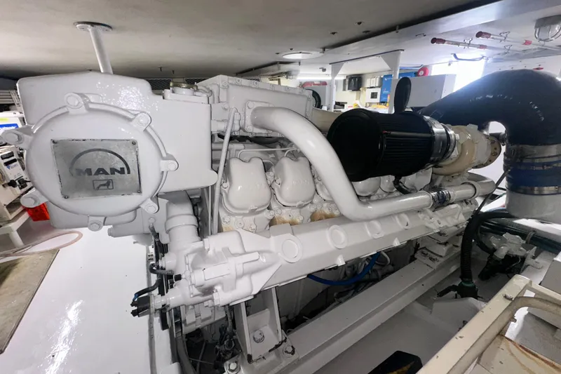 Slide: The Image of Engine room of a 1997 Viking 58 Convertible yacht featuring a MAN engine. - 166