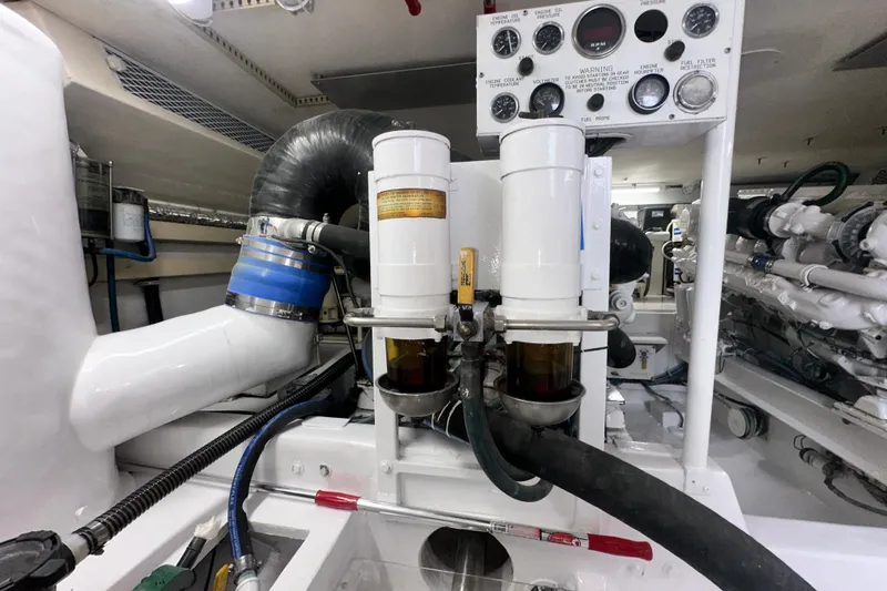 Slide: The Image of Engine room of 1997 Viking 58 Convertible yacht, showcasing fuel filters and gauges. - 169