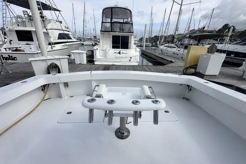 Slide: The Image of 1997 Viking 58 Convertible yacht docked at marina, surrounded by other boats. - 39