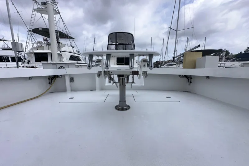 Slide: The Image of 1997 Viking 58 Convertible yacht deck with fishing rod holders, docked at marina. - 40