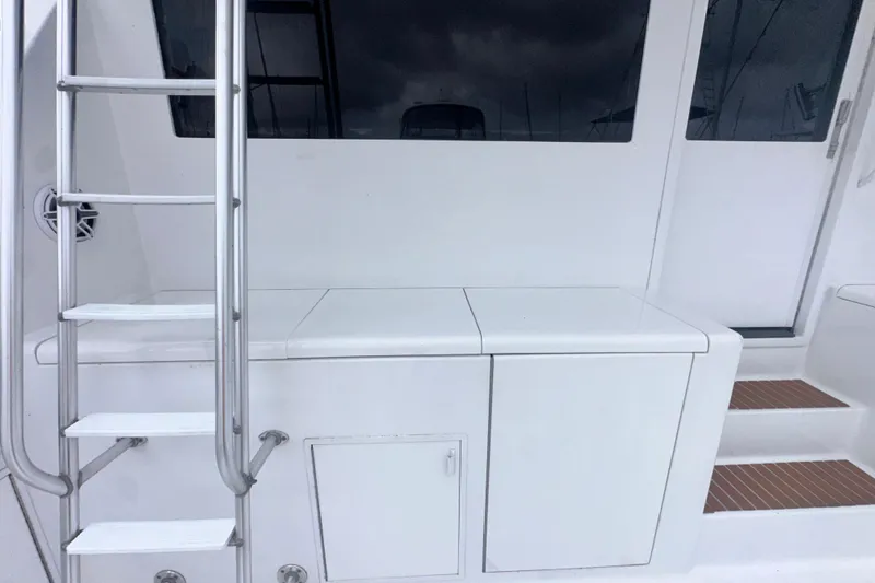 Slide: The Image of 1997 Viking 58 Convertible yacht with ladder and storage compartments. - 41