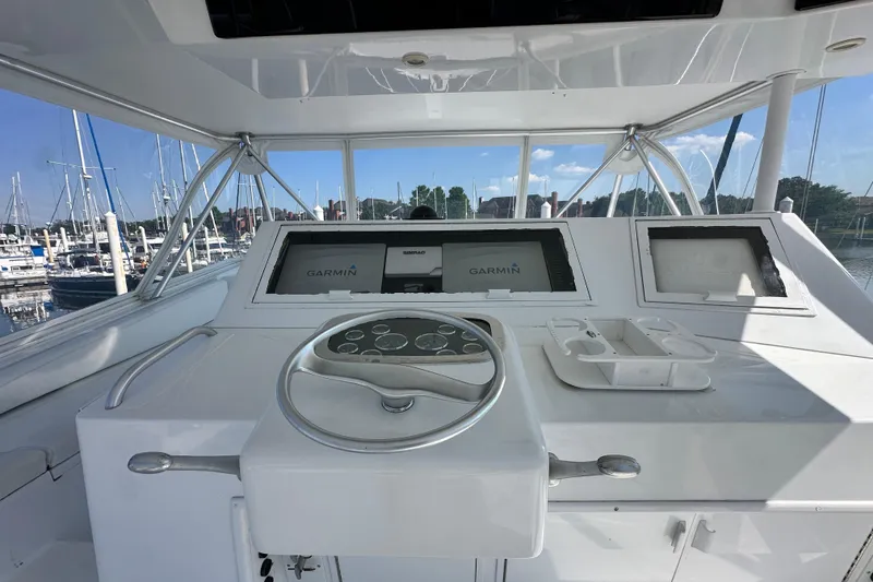 Slide: The Image of Helm of 1997 Viking 58 Convertible yacht with Garmin navigation system at marina. - 45