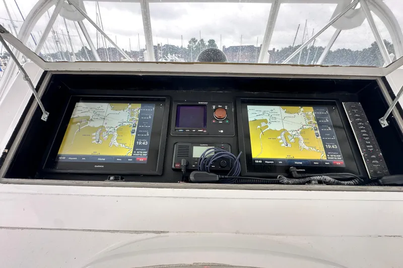 Slide: The Image of Control panel of a 1997 Viking 58 Convertible yacht with navigation screens and instruments. - 46