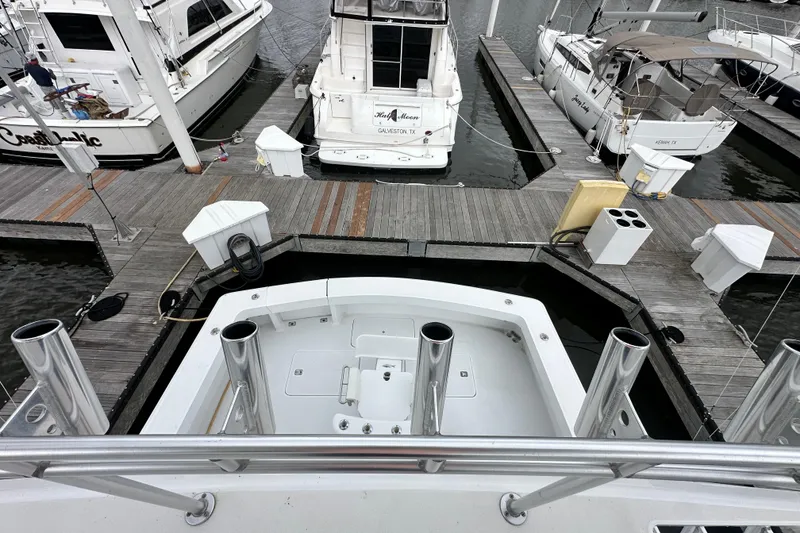 Slide: The Image of 1997 Viking 58 Convertible yacht docked at marina with other boats. - 55