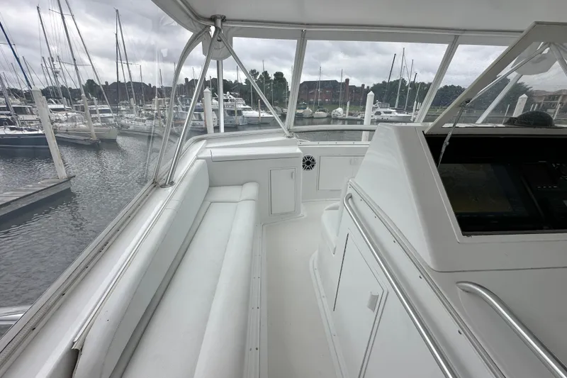 Slide: The Image of Interior view of a 1997 Viking 58 Convertible yacht at a marina. - 56