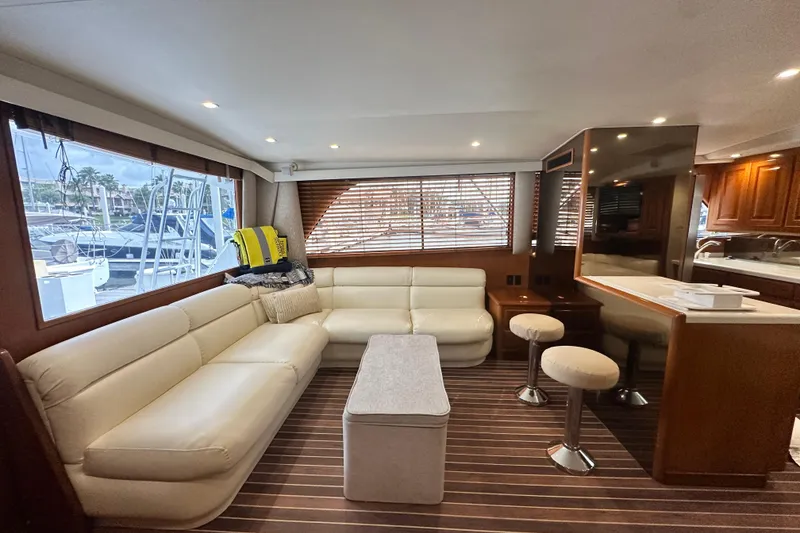 Slide: The Image of Luxurious interior of a 1997 Viking 58 Convertible yacht with plush seating and modern decor. - 59