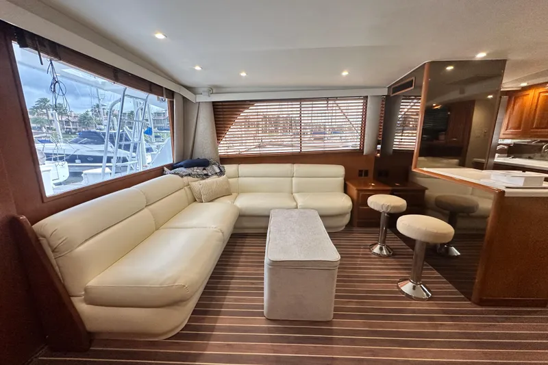 Slide: The Image of Luxurious interior of a 1997 Viking 58 Convertible yacht with plush seating and wooden accents. - 60