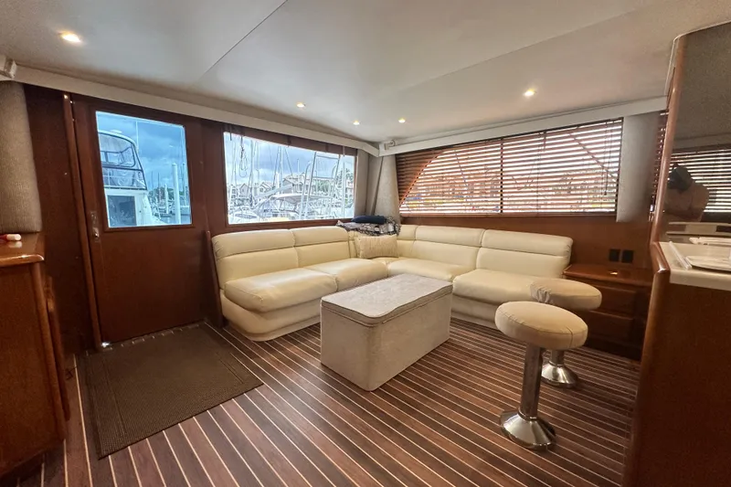 Slide: The Image of Luxurious interior of a 1997 Viking 58 Convertible yacht with plush seating and wooden accents. - 61