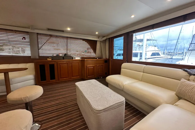 Slide: The Image of Luxurious interior of a 1997 Viking 58 Convertible yacht with plush seating and wooden accents. - 62