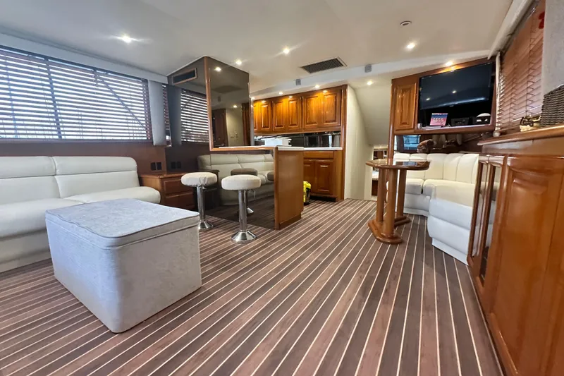Slide: The Image of Luxurious interior of a 1997 Viking 58 Convertible yacht with elegant wood finishes. - 66