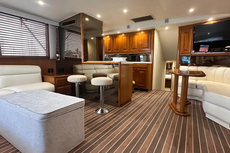 Slide: The Image of Luxurious interior of a 1997 Viking 58 Convertible yacht with elegant wood finishes. - 67