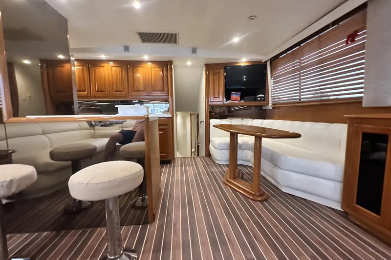 Slide: The Image of Luxurious interior of a 1997 Viking 58 Convertible yacht with wood accents and plush seating. - 71