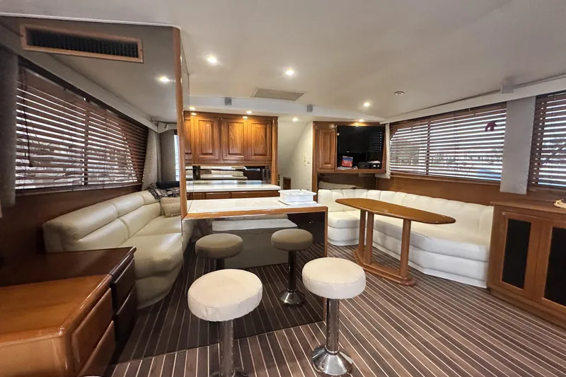 Slide: The Image of Luxurious interior of a 1997 Viking 58 Convertible yacht with plush seating and wooden accents. - 72