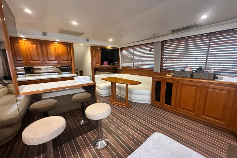 Slide: The Image of Luxurious interior of a 1997 Viking 58 Convertible yacht with wood accents and plush seating. - 73