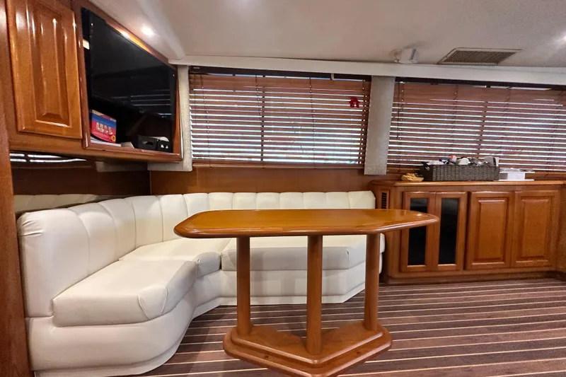 Slide: The Image of Luxurious interior of a 1997 Viking 58 Convertible yacht with elegant wood finishes. - 75