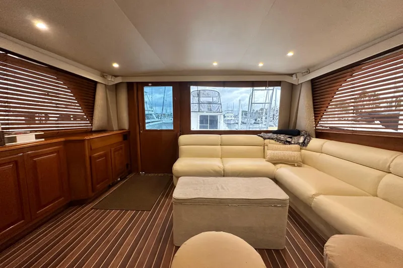 Slide: The Image of Luxurious interior of a 1997 Viking 58 Convertible yacht with plush seating and wooden accents. - 76