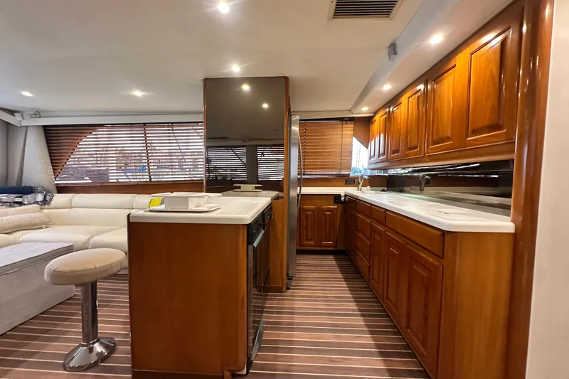Slide: The Image of Luxurious interior of a 1997 Viking 58 Convertible yacht with wooden cabinetry and modern amenities. - 77