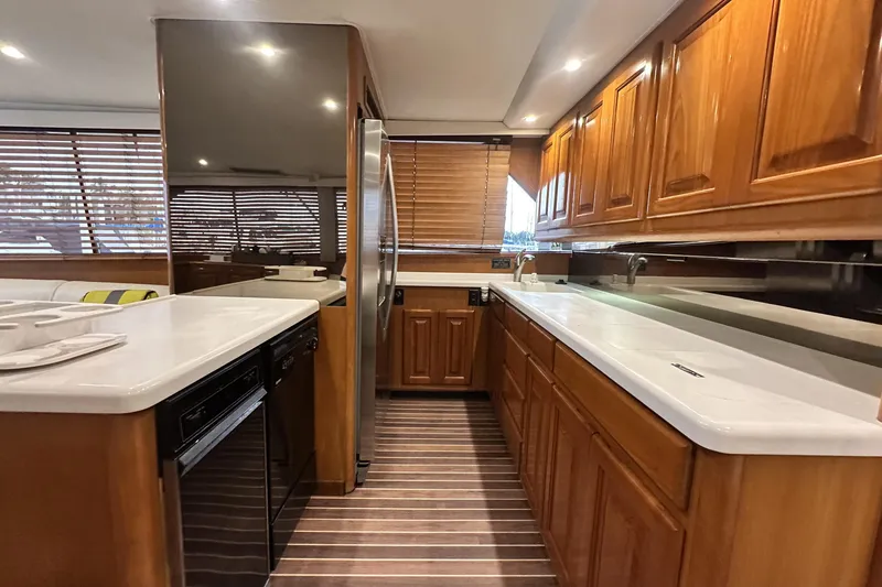 Slide: The Image of Luxurious kitchen interior of a 1997 Viking 58 Convertible yacht with wooden cabinetry. - 78