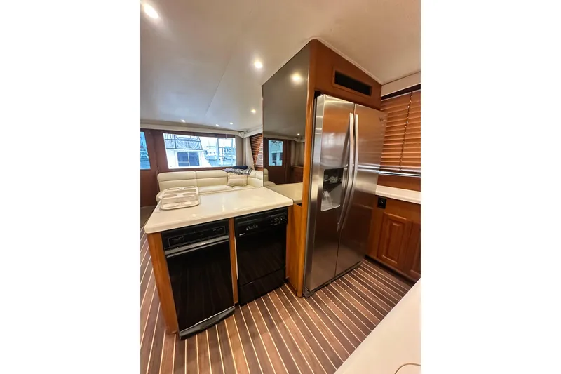 Slide: The Image of Interior of 1997 Viking 58 Convertible yacht with modern kitchen and stainless steel appliances. - 80