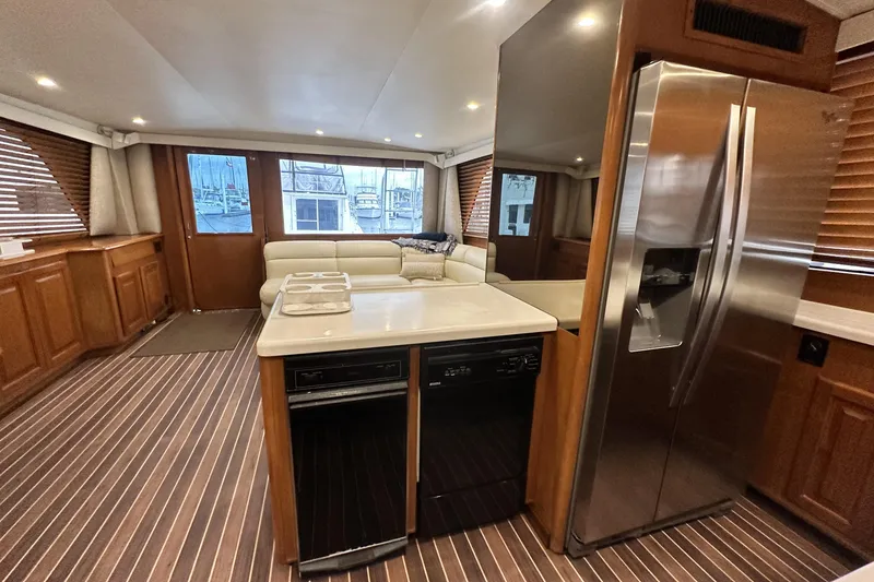 Slide: The Image of Luxurious interior of a 1997 Viking 58 Convertible yacht with modern kitchen and seating area. - 81