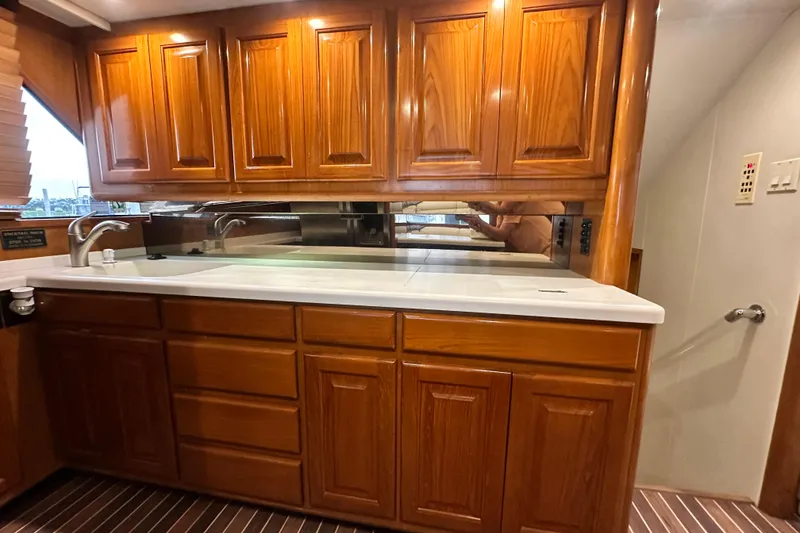 Slide: The Image of Luxurious wooden cabinetry in 1997 Viking 58 Convertible yacht kitchen interior. - 82