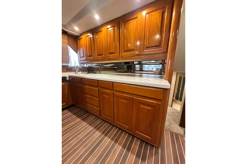 Slide: The Image of Luxurious wooden cabinetry in 1997 Viking 58 Convertible yacht kitchen interior. - 83