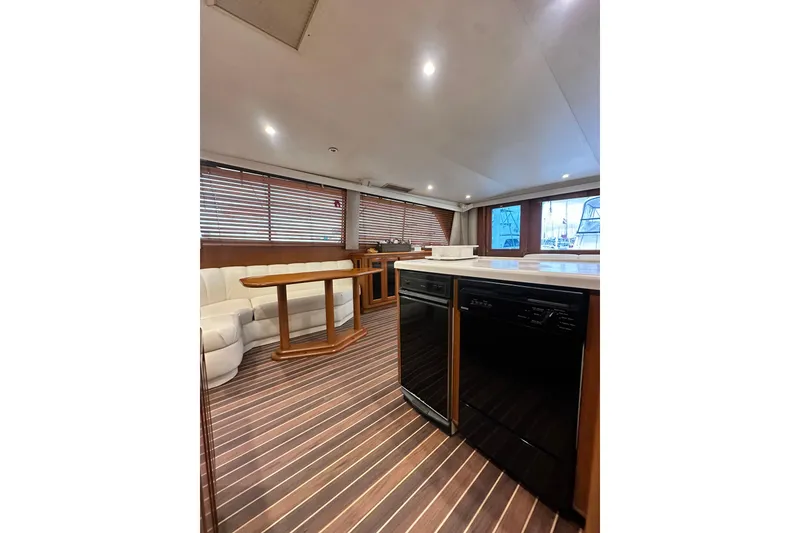 Slide: The Image of Luxurious interior of a 1997 Viking 58 Convertible yacht with wood flooring and modern amenities. - 85
