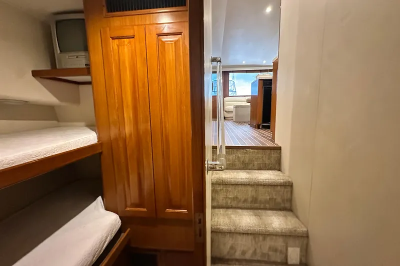 Slide: The Image of Interior of 1997 Viking 58 Convertible yacht with wooden cabinetry and bunk beds. - 90