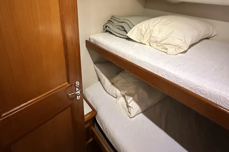 Slide: The Image of Bunk beds in 1997 Viking 58 Convertible yacht cabin with wooden door. - 91