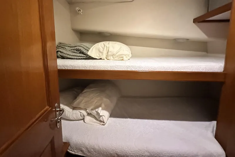 Slide: The Image of Bunk beds in 1997 Viking 58 Convertible yacht cabin with cozy bedding. - 92