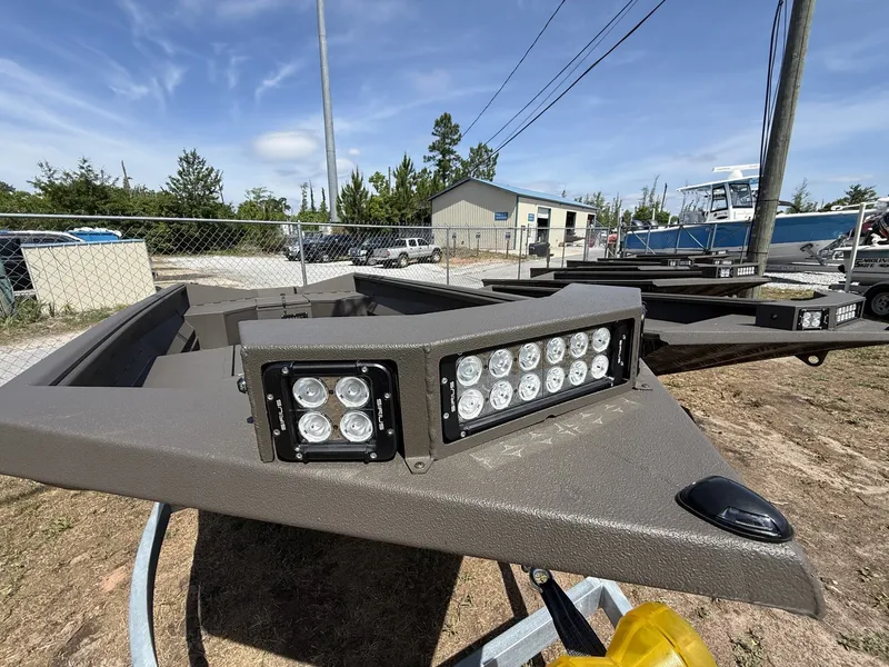 Slide: The Image of 2026 Reaper Boats 553 with LED lights outdoors. - 2