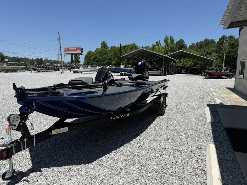 Slide: The Image of 2026 Lowe Stinger 195 Bass boat on gravel lot. - 3
