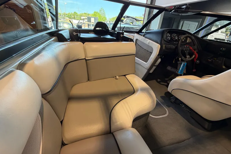 Slide: The Image of Interior of a 2003 Malibu Wakesetter 21 VLX boat with beige seating and dashboard. - 10