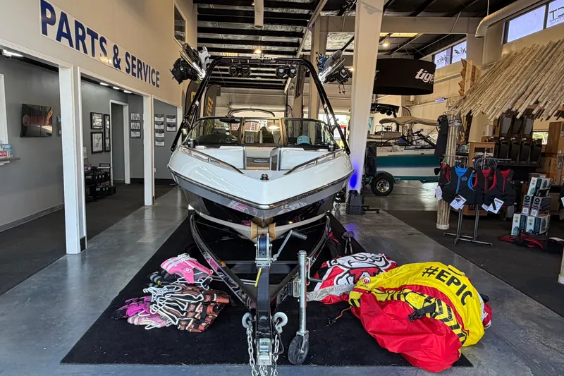 Slide: The Image of 2003 Malibu Wakesetter 21 VLX displayed in a showroom with accessories. - 2